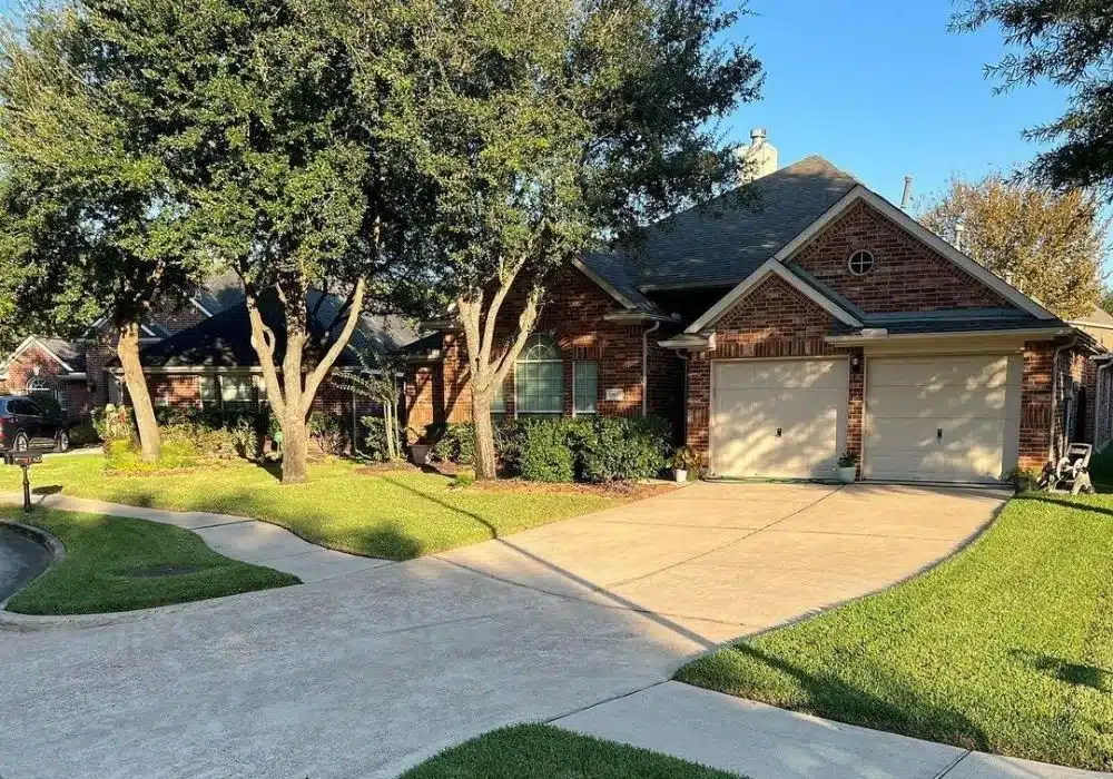 Well maintained front lawn featuring evergreen shrubs located in summerwood, tx